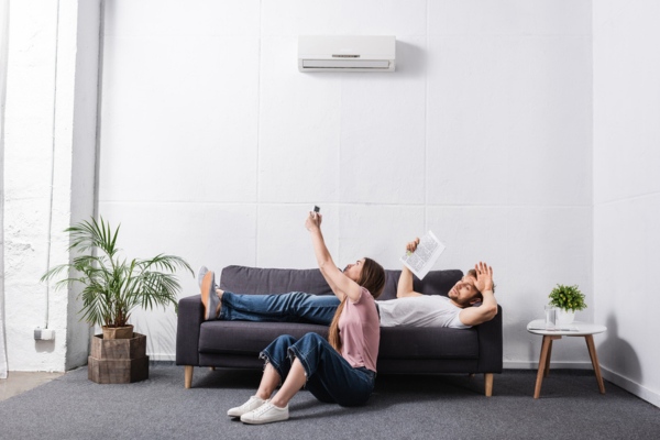 couple in the living room feeling warm with broken air conditioner