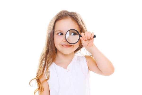 young girl looking through a magnifying glass depicting signs of leaking HVAC ductwork