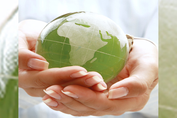 image of hands and earth depicting how to reduce carbon emissions